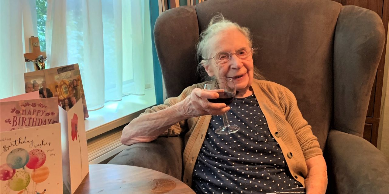 Winifred raises a glass of red to her 102nd birthday