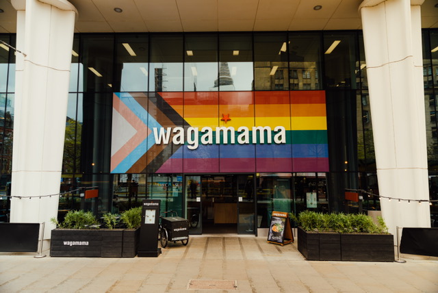 wagamama updates its giant pride flag to the progressive pride flag at Manchester St Peters Square restaurant.